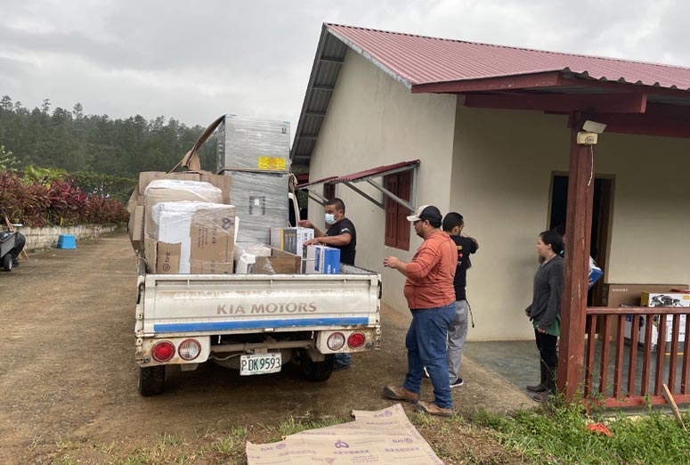 Workers outside the new Lynn's Casa unloading materials for final preparations.